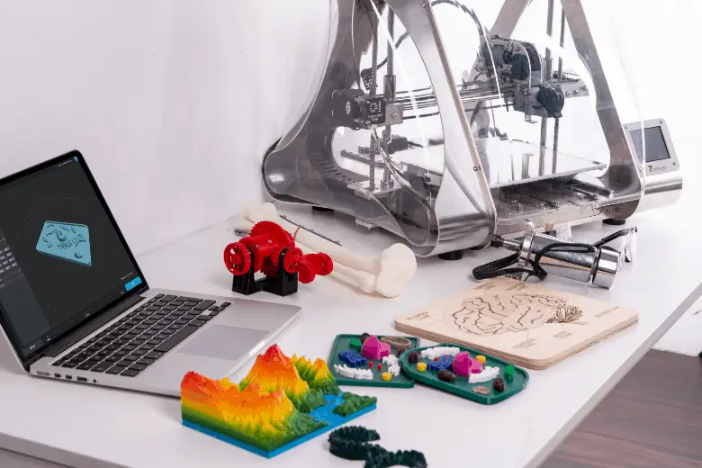 Desktop with 3d printer and colorful 3d printed objects