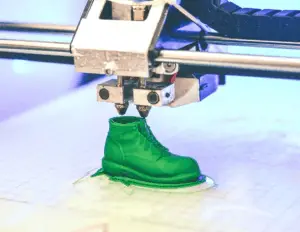 dual extruder 3d printer printing green shoe
