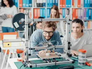 man and woman using 3D printer